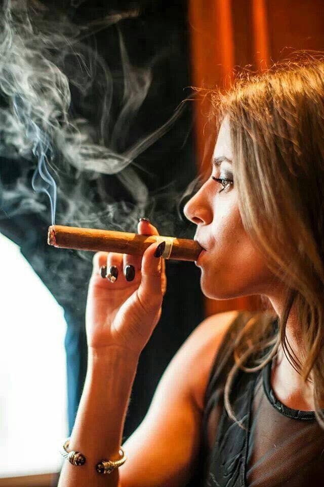 Brunette smoking cigar the stairs