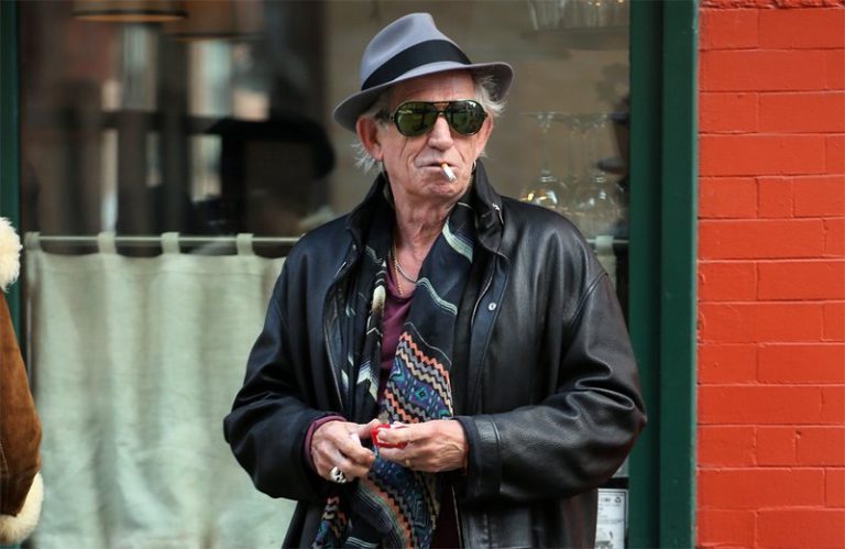 The Rolling Stones guitarist Keith Richards smoking cigar and cigarette