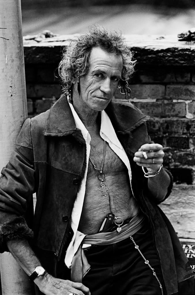 The Rolling Stones guitarist Keith Richards smoking cigar and cigarette