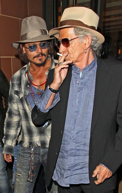 The Rolling Stones guitarist Keith Richards smoking cigar and cigarette